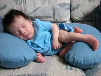 Kyla takes a nap inside of a breastfeeding pillow