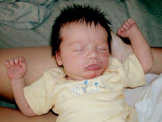 Kyla has milk on her face after breastfeeding